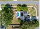 Birds-eye view displaying a home with a pool, set within a residential community with large, tree-filled yards at 13372 Dewey Ct, Spring Hill, FL 34609