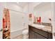 Bathroom with shower-tub combo, granite countertop, and dark vanity at 13454 Golden Lime Ave, Spring Hill, FL 34609