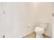 Cozy half-bathroom features a white toilet, neutral paint, and clean, simple fixtures at 13454 Golden Lime Ave, Spring Hill, FL 34609