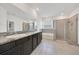 Main bathroom with double vanity, shower, tub, and tile flooring at 13454 Golden Lime Ave, Spring Hill, FL 34609