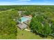 Aerial view of the community pool and clubhouse with mature landscaping and abundant seating at 13454 Golden Lime Ave, Spring Hill, FL 34609