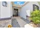 Inviting front entrance with decorative sunflower wreath, 'WELCOME' sign, and textured stone accents at 13454 Golden Lime Ave, Spring Hill, FL 34609
