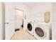 Functional laundry room with a washer, dryer, shelving, and space for organizing laundry essentials at 13454 Golden Lime Ave, Spring Hill, FL 34609