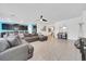 Bright living room showcasing a comfortable sectional sofa with views to the kitchen and dining area at 13454 Golden Lime Ave, Spring Hill, FL 34609