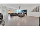 An open-concept living area featuring a large sectional sofa and sliding glass doors to the outdoor space at 13454 Golden Lime Ave, Spring Hill, FL 34609