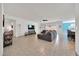Spacious living room with tile flooring, a modern sectional sofa, and ample natural light at 13454 Golden Lime Ave, Spring Hill, FL 34609