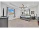 Bright main bedroom featuring tray ceilings and a ceiling fan at 13454 Golden Lime Ave, Spring Hill, FL 34609