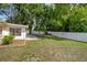 A spacious backyard featuring a well-kept lawn, a brick patio, and a privacy fence at 13923 Pathfinder Dr, Tampa, FL 33625