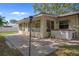 Backyard patio featuring a brick paved area with a sunroom and a built-in hot tub at 13923 Pathfinder Dr, Tampa, FL 33625