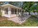 Cozy backyard patio with brick pavers and a charming sunroom extension at 13923 Pathfinder Dr, Tampa, FL 33625