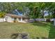 Secluded backyard with a brick patio, fire pit, and perimeter fencing at 13923 Pathfinder Dr, Tampa, FL 33625