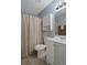 Bathroom featuring a white vanity, toilet, medicine cabinet, and a shower with a curtain at 13923 Pathfinder Dr, Tampa, FL 33625