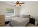 Comfortable bedroom features ceiling fan, window, and a gray bed set, creating a relaxing ambiance at 13923 Pathfinder Dr, Tampa, FL 33625