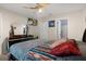 Cozy bedroom featuring ceiling fan, mounted TV, and walk-in closet for comfort and entertainment at 13923 Pathfinder Dr, Tampa, FL 33625