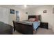 Comfortable bedroom features a ceiling fan, neutral walls, and a dark wood bed frame at 13923 Pathfinder Dr, Tampa, FL 33625