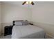Cozy bedroom featuring neutral-toned walls, dark furniture, and soft gray bedding at 13923 Pathfinder Dr, Tampa, FL 33625