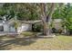 Lovely single-story house with manicured lawn and mature tree at 13923 Pathfinder Dr, Tampa, FL 33625