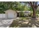 Charming single-story home with lush landscaping and mature trees at 13923 Pathfinder Dr, Tampa, FL 33625