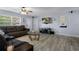 Bright living room with a comfortable brown sofa, modern decor, and natural light at 13923 Pathfinder Dr, Tampa, FL 33625