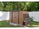 Backyard storage shed with a planter box and lattice accent, set against a privacy fence at 13923 Pathfinder Dr, Tampa, FL 33625
