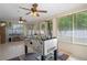 Bright sunroom with multiple windows, ceiling fans, and a foosball table at 13923 Pathfinder Dr, Tampa, FL 33625