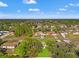 An aerial view showcasing a neighborhood featuring mature trees and well-kept lawns on a sunny day at 13935 Coronado Dr, Spring Hill, FL 34609