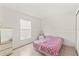 Bright bedroom features a large window with lots of natural light and tile flooring at 13935 Coronado Dr, Spring Hill, FL 34609