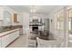 Eat-in kitchen features modern appliances, white cabinets, and a large sliding glass door at 13935 Coronado Dr, Spring Hill, FL 34609