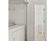Convenient laundry area with washer, dryer, and storage shelving for organization at 13935 Coronado Dr, Spring Hill, FL 34609