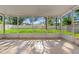 Relaxing screened patio overlooks a spacious backyard with lush green grass at 13935 Coronado Dr, Spring Hill, FL 34609