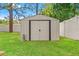 Durable storage shed in a well-maintained backyard offers ample space at 13935 Coronado Dr, Spring Hill, FL 34609