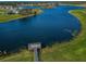 Stunning aerial view of the community lake and the pier at 14008 Lugano Ct, Hudson, FL 34669
