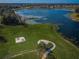 Aerial shot of the community park with a picnic area, fire pit, and walking trails by the lake at 14008 Lugano Ct, Hudson, FL 34669