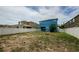 Large backyard with privacy fence, fire pit, and a covered patio attached to the blue home at 14008 Lugano Ct, Hudson, FL 34669