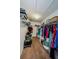 Walk-in closet with shelving provides ample storage space for clothes and accessories at 14008 Lugano Ct, Hudson, FL 34669