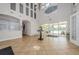 Bright clubhouse foyer with stylish decor, tiled floors, and views of the pool at 14008 Lugano Ct, Hudson, FL 34669