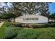 Lakeside community entrance sign surrounded by lush greenery on a sunny day at 14008 Lugano Ct, Hudson, FL 34669