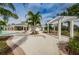 Scenic community pool with covered seating and lush tropical landscaping at 14008 Lugano Ct, Hudson, FL 34669
