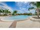 Beautiful community pool with splash pad surrounded by lush landscaping at 14008 Lugano Ct, Hudson, FL 34669