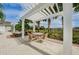 Charming covered patio with outdoor dining area and pergola at 14008 Lugano Ct, Hudson, FL 34669
