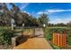 View of the community dog park, complete with waste station and lush landscaping at 14008 Lugano Ct, Hudson, FL 34669