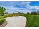 Inviting community fire pit area with Adirondack chairs and lush green space at 14008 Lugano Ct, Hudson, FL 34669