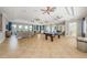 Large game room featuring a pool table, tile floors, plenty of seating, and multiple ceiling fans at 14008 Lugano Ct, Hudson, FL 34669