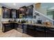 Stylish kitchen with stainless steel appliances, granite countertops, and custom cabinetry at 14008 Lugano Ct, Hudson, FL 34669