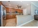 Eat-in kitchen featuring stainless steel appliances, granite countertops, wood cabinets, and tile flooring at 14008 Lugano Ct, Hudson, FL 34669