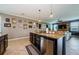 Spacious kitchen featuring a granite-topped island, stainless steel appliances, and open layout at 14008 Lugano Ct, Hudson, FL 34669