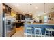 Modern kitchen boasts stainless steel appliances, custom cabinets, granite counters, and breakfast bar at 14008 Lugano Ct, Hudson, FL 34669