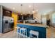 Open kitchen featuring dark cabinetry, granite countertops, and a convenient breakfast bar with stool seating at 14008 Lugano Ct, Hudson, FL 34669