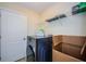 Laundry room featuring a modern washing machine and shelving for storage and cleaning supplies at 14008 Lugano Ct, Hudson, FL 34669
