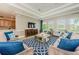 Spacious living room with couches, throw pillows, rug, TV, and views from three windows at 14008 Lugano Ct, Hudson, FL 34669